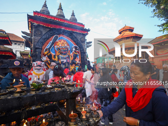 A Nepali Hindu devotee offers prayers to Kaal Bhairav in Kathmandu Durbar Square in Kathmandu, Nepal, on October 11, 2024, on the final day...