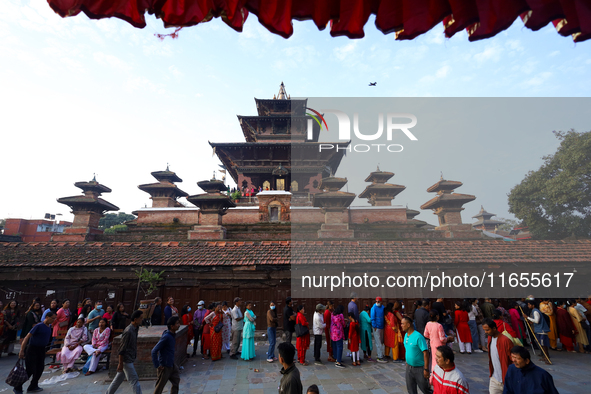 Nepali Hindu devotees stand in a queue to reach the Taleju Bhawani Temple in Kathmandu Durbar Square, Nepal, on October 11, 2024, on the fin...