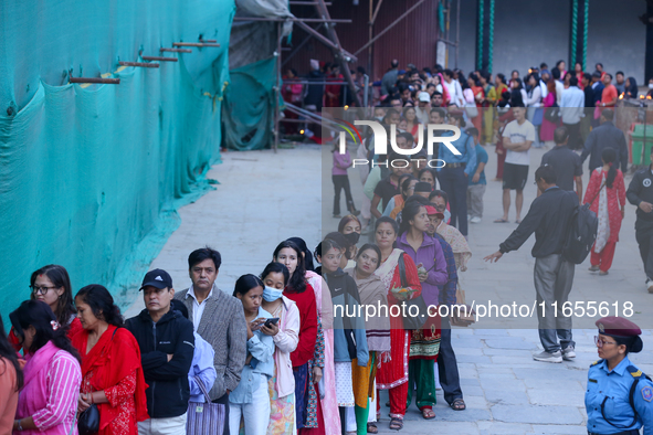 Nepali Hindu devotees stand in a queue to reach the Taleju Bhawani Temple in Kathmandu Durbar Square, Nepal, on October 11, 2024, on the fin...