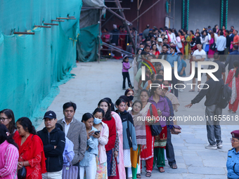 Nepali Hindu devotees stand in a queue to reach the Taleju Bhawani Temple in Kathmandu Durbar Square, Nepal, on October 11, 2024, on the fin...