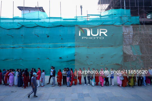 Nepali Hindu devotees stand in a queue to reach the Taleju Bhawani Temple in Kathmandu Durbar Square, Nepal, on October 11, 2024, on the fin...