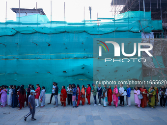 Nepali Hindu devotees stand in a queue to reach the Taleju Bhawani Temple in Kathmandu Durbar Square, Nepal, on October 11, 2024, on the fin...