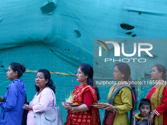 Nepali Hindu devotees stand in a queue to reach the Taleju Bhawani Temple in Kathmandu Durbar Square, Nepal, on October 11, 2024, on the fin...