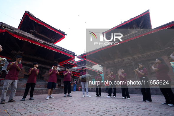 A chorus of a local musical band plays music in Basantapur Durbar Square, Nepal, on October 11, 2024. 