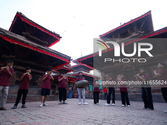 A chorus of a local musical band plays music in Basantapur Durbar Square, Nepal, on October 11, 2024. (