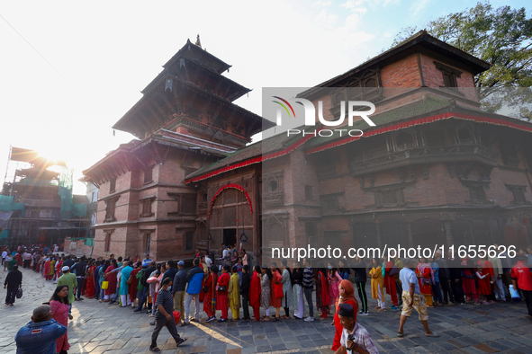 Nepali Hindu devotees stand in a queue to reach the Taleju Bhawani Temple in Kathmandu Durbar Square, Nepal, on October 11, 2024, on the fin...