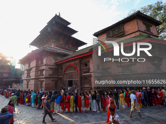 Nepali Hindu devotees stand in a queue to reach the Taleju Bhawani Temple in Kathmandu Durbar Square, Nepal, on October 11, 2024, on the fin...