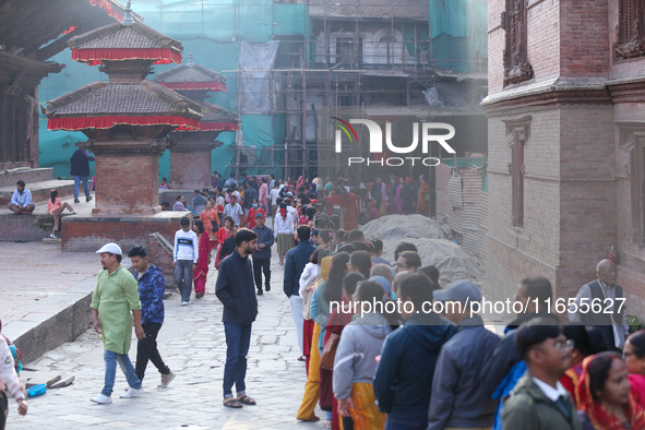 Nepali Hindu devotees stand in a queue to reach the Taleju Bhawani Temple in Kathmandu Durbar Square, Nepal, on October 11, 2024, on the fin...