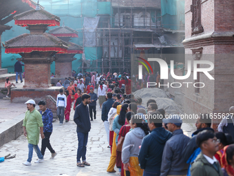 Nepali Hindu devotees stand in a queue to reach the Taleju Bhawani Temple in Kathmandu Durbar Square, Nepal, on October 11, 2024, on the fin...