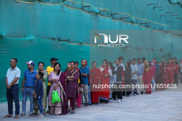 Nepali Hindu devotees stand in a queue to reach the Taleju Bhawani Temple in Kathmandu Durbar Square, Nepal, on October 11, 2024, on the fin...