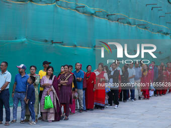 Nepali Hindu devotees stand in a queue to reach the Taleju Bhawani Temple in Kathmandu Durbar Square, Nepal, on October 11, 2024, on the fin...