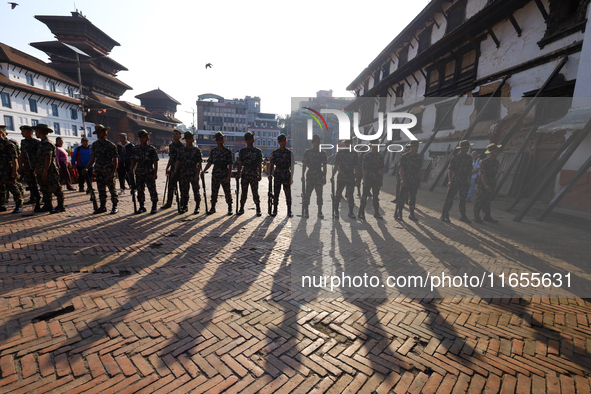 Nepal Army personnel stand guard in the courtyard of Kathmandu Durbar Square as the procession for the day of Nawaratri, also called Maha Na...