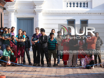 People watch the Maha Nawami procession at Kathmandu Durbar Square in Kathmandu, Nepal, on October 11, 2024, the final day of Navaratri. (