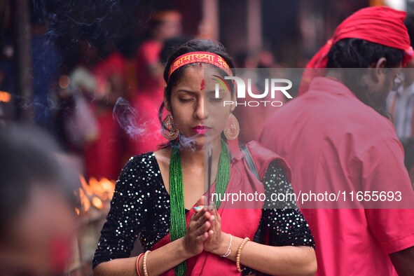 Devotees offer prayer at the Kamakhya temple for the Hindu festival of Navratri in Guwahati, India, on October 2, 2022. 