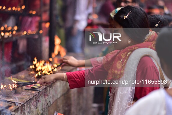 Devotees offer prayer at the Kamakhya temple for the Hindu festival of Navratri in Guwahati, India, on October 2, 2022. 