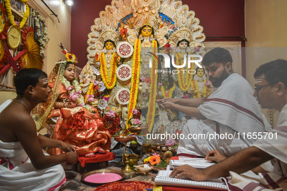 Esha Chatterjee, an eight-year-old girl dressed as a Kumari, is worshipped by a priest during the religious festival of Durga Puja in Kolkat...