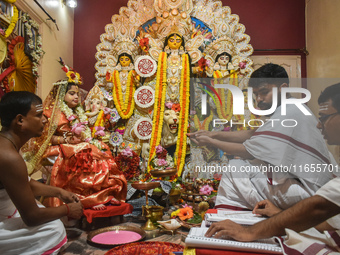 Esha Chatterjee, an eight-year-old girl dressed as a Kumari, is worshipped by a priest during the religious festival of Durga Puja in Kolkat...