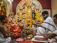 Esha Chatterjee, an eight-year-old girl dressed as a Kumari, is worshipped by a priest during the religious festival of Durga Puja in Kolkat...