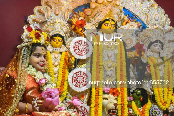 Esha Chatterjee, an eight-year-old girl dressed as a Kumari, is worshiped by a priest during the religious festival of Durga Puja in Kolkata...