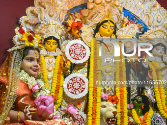 Esha Chatterjee, an eight-year-old girl dressed as a Kumari, is worshiped by a priest during the religious festival of Durga Puja in Kolkata...