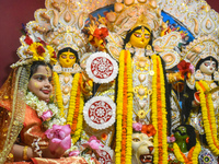 Esha Chatterjee, an eight-year-old girl dressed as a Kumari, is worshiped by a priest during the religious festival of Durga Puja in Kolkata...