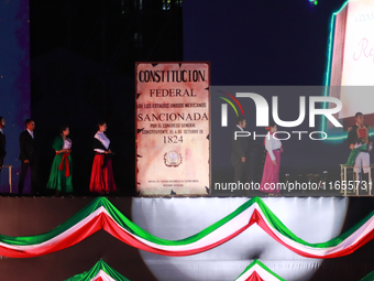 Participants perform a show during the ceremony commemorating the 200th anniversary of the Mexican Republic in Mexico City, Mexico, on Octob...