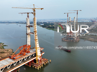 Construction workers work on the Nanchang-Jiujiang High-speed Railway Ganjiang River Highway and Railway Bridge, China's first 350 km/h mixe...