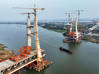 Construction workers work on the Nanchang-Jiujiang High-speed Railway Ganjiang River Highway and Railway Bridge, China's first 350 km/h mixe...