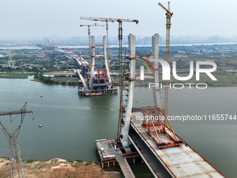 Construction workers work on the Nanchang-Jiujiang High-speed Railway Ganjiang River Highway and Railway Bridge, China's first 350 km/h mixe...