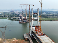 Construction workers work on the Nanchang-Jiujiang High-speed Railway Ganjiang River Highway and Railway Bridge, China's first 350 km/h mixe...