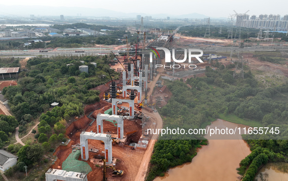 Construction workers work on the Nanchang-Jiujiang High-speed Railway Ganjiang River Highway and Railway Bridge, China's first 350 km/h mixe...