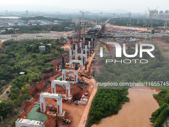 Construction workers work on the Nanchang-Jiujiang High-speed Railway Ganjiang River Highway and Railway Bridge, China's first 350 km/h mixe...