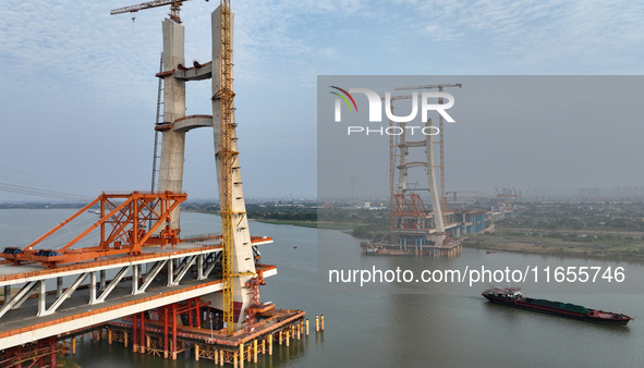 Construction workers work on the Nanchang-Jiujiang High-speed Railway Ganjiang River Highway and Railway Bridge, China's first 350 km/h mixe...