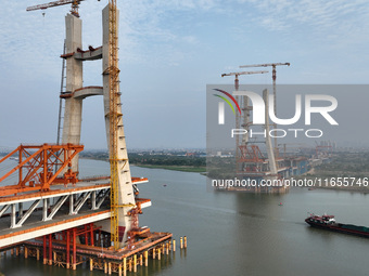 Construction workers work on the Nanchang-Jiujiang High-speed Railway Ganjiang River Highway and Railway Bridge, China's first 350 km/h mixe...