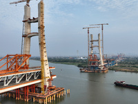 Construction workers work on the Nanchang-Jiujiang High-speed Railway Ganjiang River Highway and Railway Bridge, China's first 350 km/h mixe...