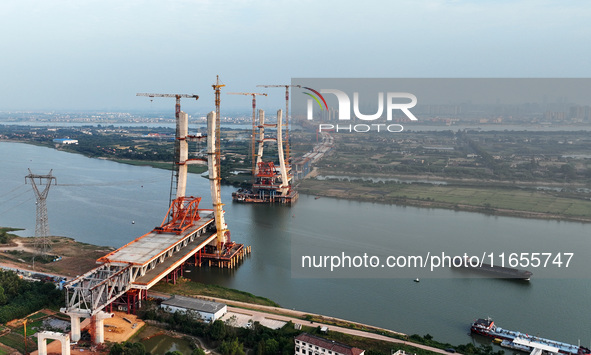 Construction workers work on the Nanchang-Jiujiang High-speed Railway Ganjiang River Highway and Railway Bridge, China's first 350 km/h mixe...