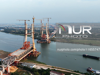 Construction workers work on the Nanchang-Jiujiang High-speed Railway Ganjiang River Highway and Railway Bridge, China's first 350 km/h mixe...