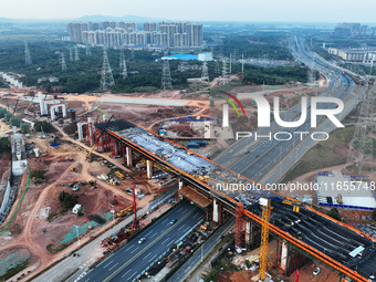 Construction workers work on the Nanchang-Jiujiang High-speed Railway Ganjiang River Highway and Railway Bridge, China's first 350 km/h mixe...