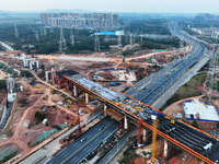 Construction workers work on the Nanchang-Jiujiang High-speed Railway Ganjiang River Highway and Railway Bridge, China's first 350 km/h mixe...