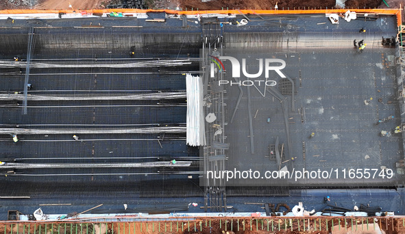 Construction workers work on the Nanchang-Jiujiang High-speed Railway Ganjiang River Highway and Railway Bridge, China's first 350 km/h mixe...