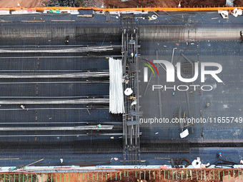 Construction workers work on the Nanchang-Jiujiang High-speed Railway Ganjiang River Highway and Railway Bridge, China's first 350 km/h mixe...