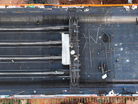 Construction workers work on the Nanchang-Jiujiang High-speed Railway Ganjiang River Highway and Railway Bridge, China's first 350 km/h mixe...