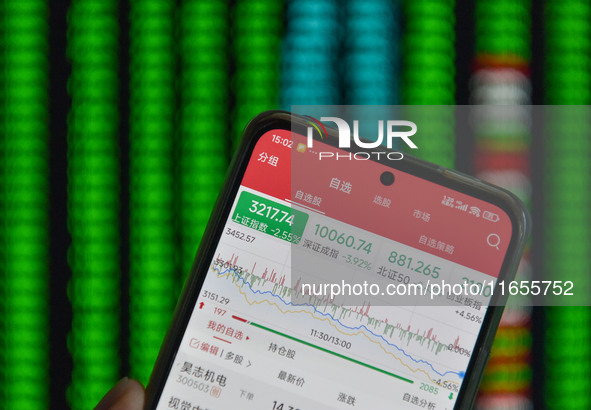 The day's stock index closing point appears on the mobile phone of a citizen in Fuyang, China, on October 11, 2024. 