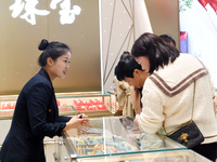 Consumers shop for gold jewelry at a gold store in Renhuai, China, on October 11, 2024. (