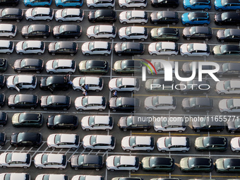 Vehicles parked at an automobile manufacturer are about to be shipped to the market in Ningde, China, on October 10, 2024. (