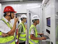 Technicians perform grid-connected power supply operations in a computer room in Liuzhou, China, on October 10, 2024. (