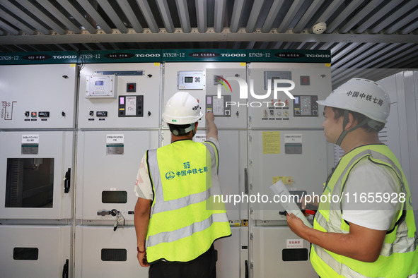 Technicians perform grid-connected power supply operations in a computer room in Liuzhou, China, on October 10, 2024. 