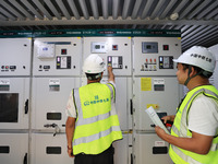 Technicians perform grid-connected power supply operations in a computer room in Liuzhou, China, on October 10, 2024. (