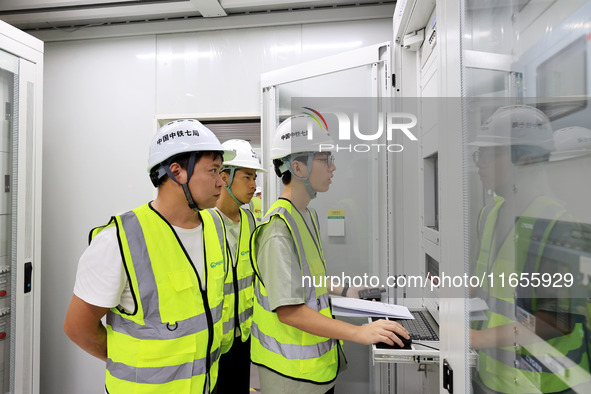 Technicians perform grid-connected power supply operations in a computer room in Liuzhou, China, on October 10, 2024. 