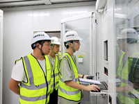 Technicians perform grid-connected power supply operations in a computer room in Liuzhou, China, on October 10, 2024. (